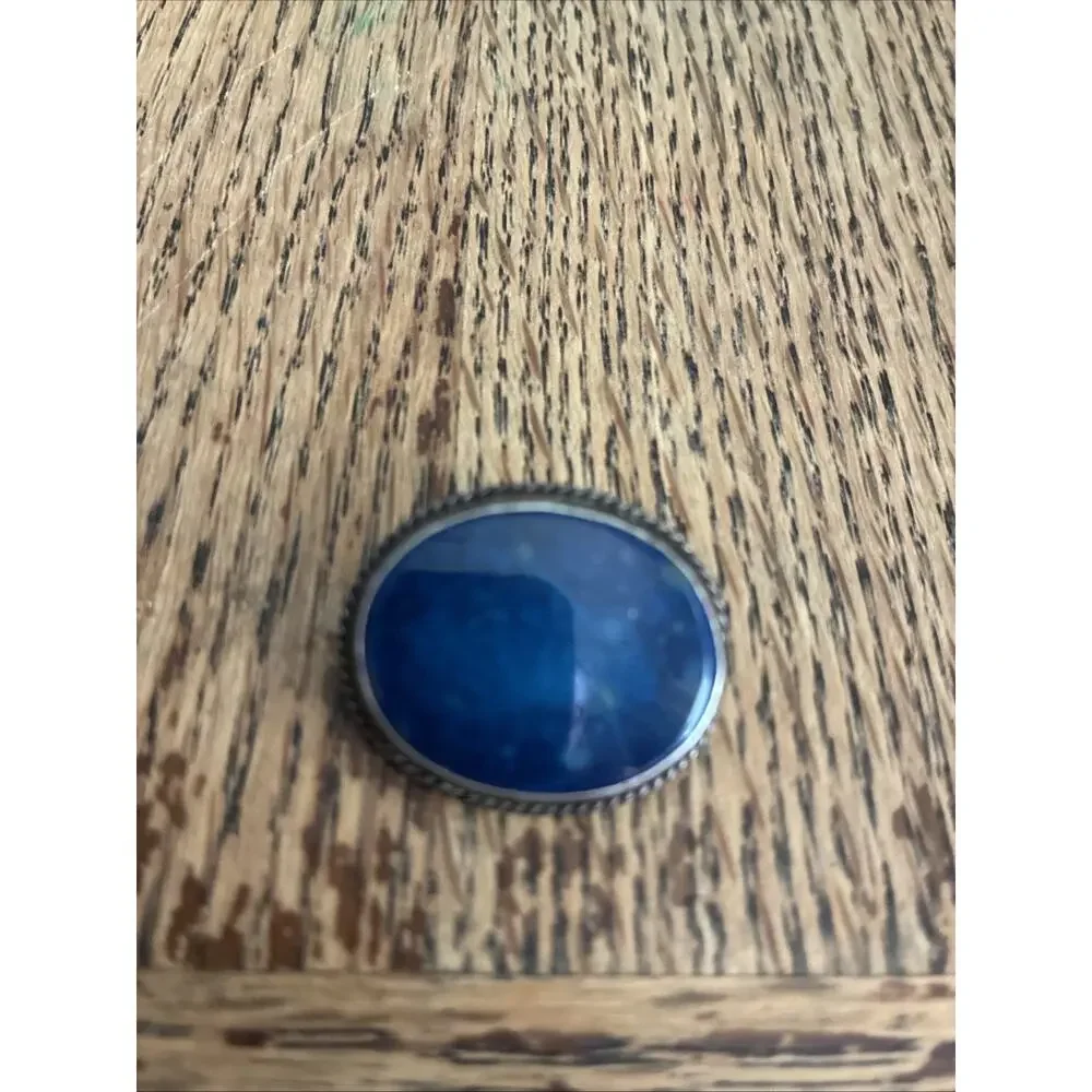 A Vintage Navajo Sterling Silver Sand Cast Brooch With A Lapis Cabochon